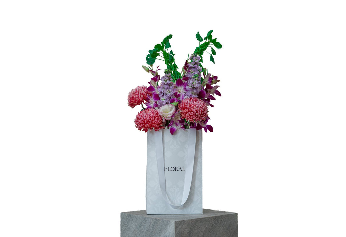 Velvet Wonderland by FLORAL: coral-pink chrysanthemums and purple dendrobium orchids
