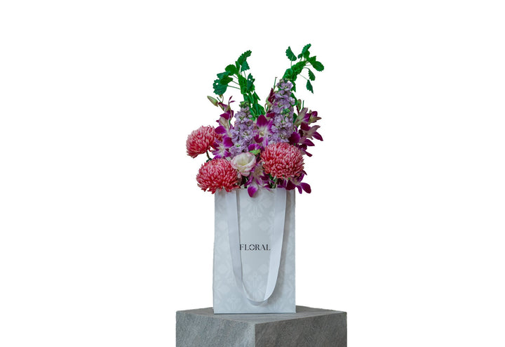 Velvet Wonderland by FLORAL: coral-pink chrysanthemums and purple dendrobium orchids